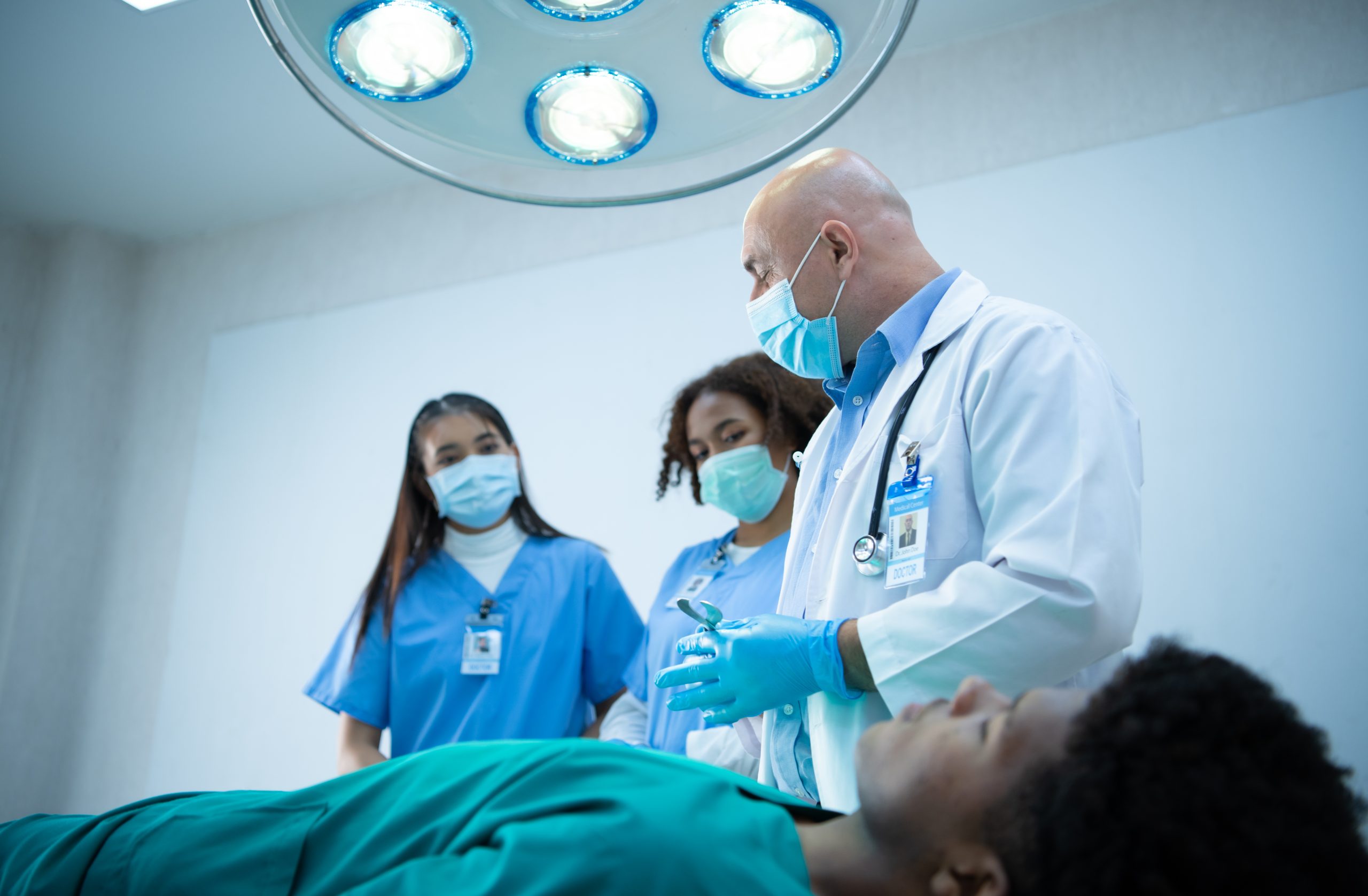 A medical professor is teaching surgery to medical students working at an international medical hospital.